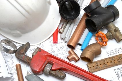 Plumbing parts, tools, and plans used by Pink Flamingo Plumbing.